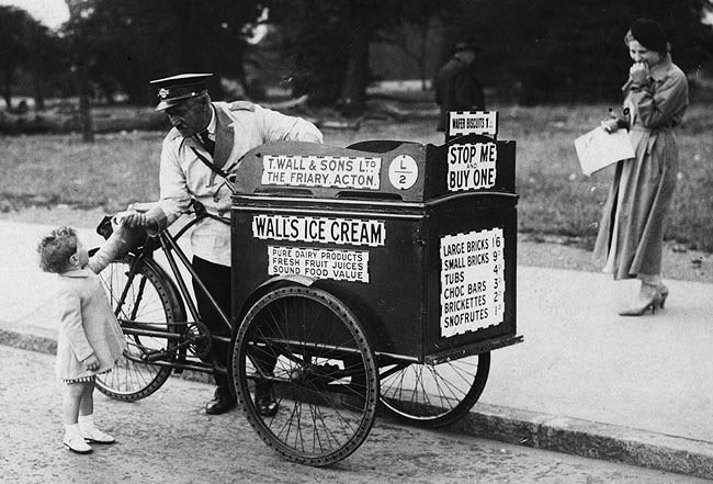 3rd September 1935:  The 'Stop Me And Buy One'  Walls Ice Cream Tricycle salesman gets a small customer.  (Photo by David Savill/Topical Press Agency/Getty Images)